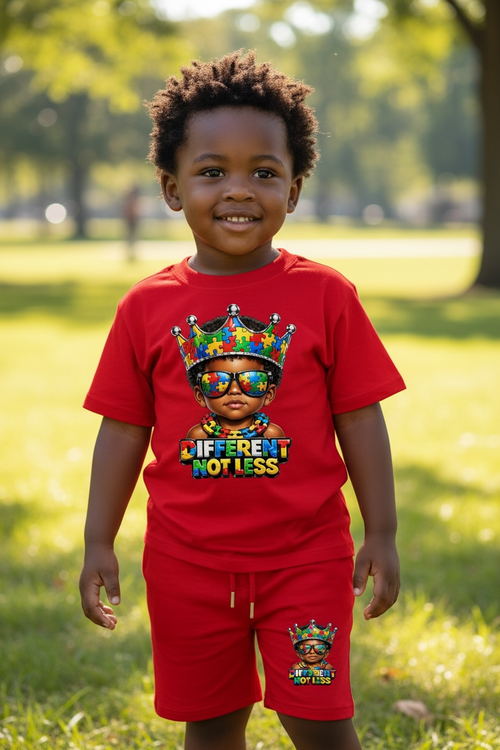 Child wearing a red shirt and shorts with colorful graphics and text in a park.